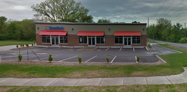 the outside of a restaurant with a parking lot