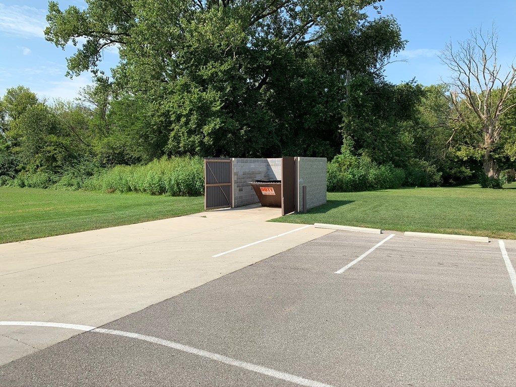 an empty parking lot with a toilet in it