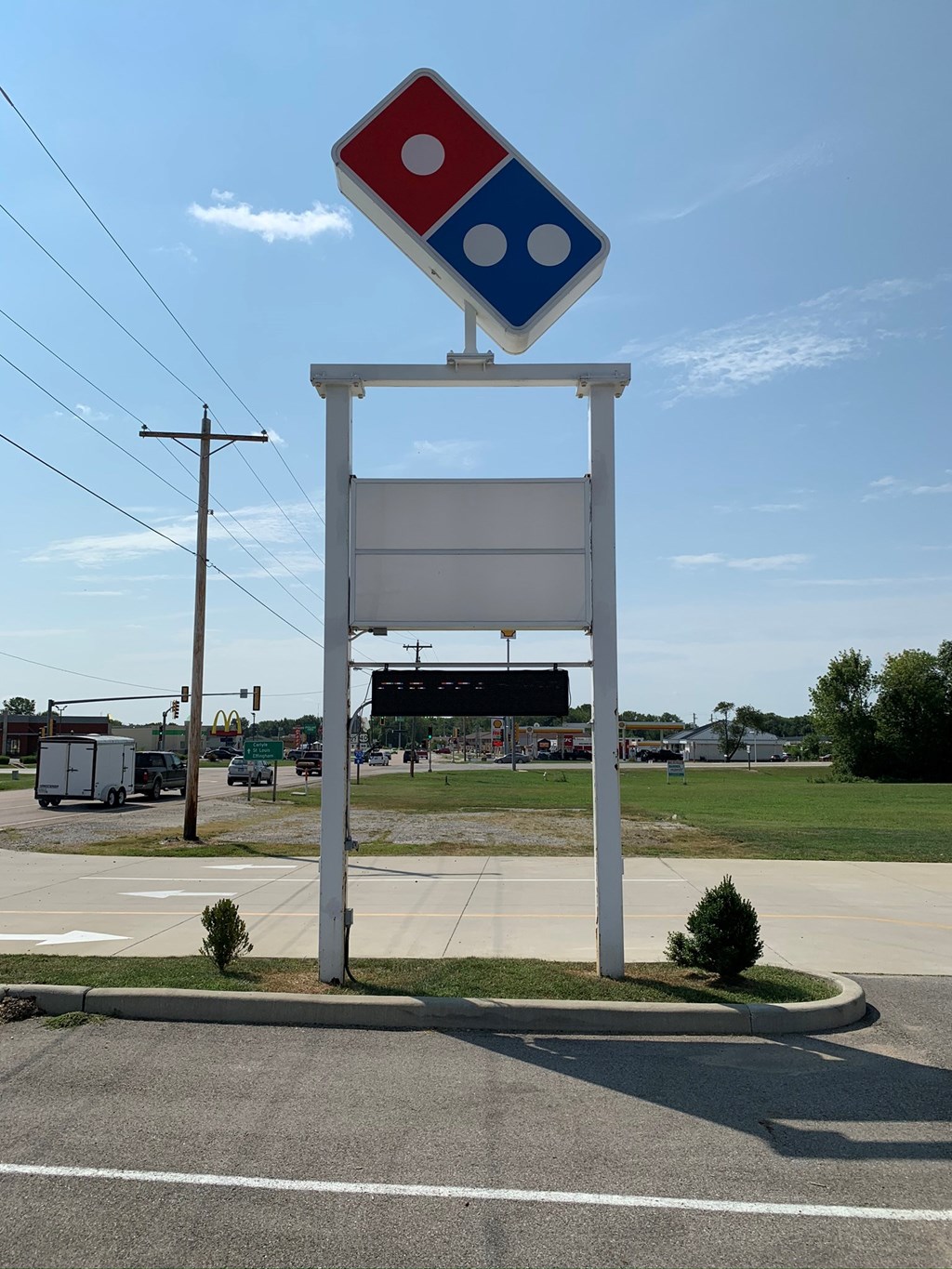 a sign for a gas station on the side of the road