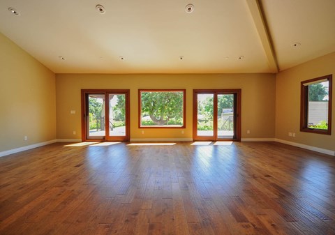 A room with wooden floors and windows.