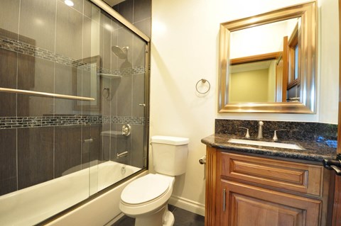 A bathroom with a toilet, sink, and shower.