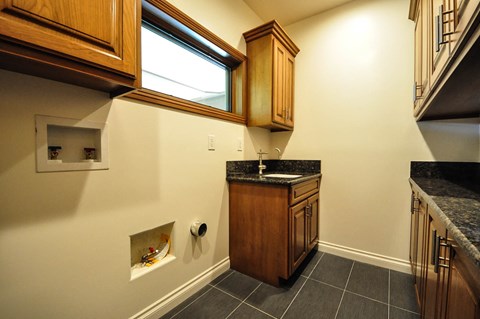 A kitchen with wooden cabinets and a granite countertop.