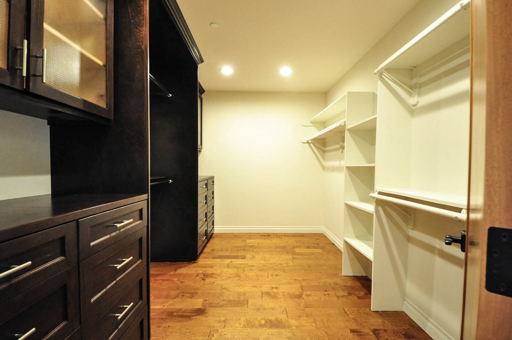 A kitchen with black cabinets and a white refrigerator.