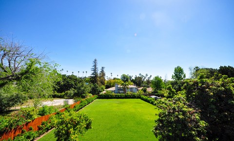 A beautifully manicured lawn with a house in the background.