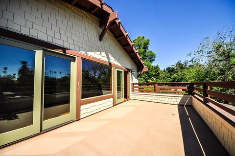 A house with a red tile roof and a glass door.