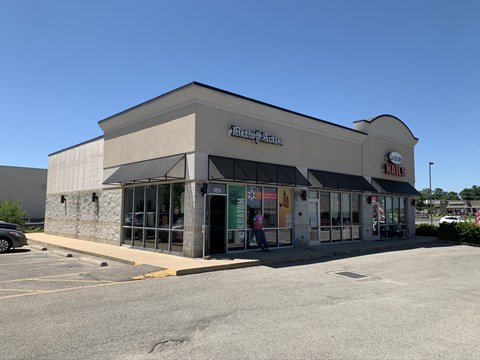 A Petrol Station with a car parked in front.