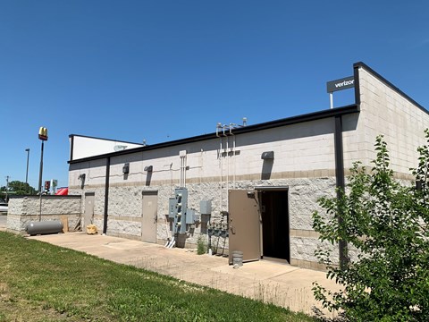 A Verizon building with a clear blue sky in the background.