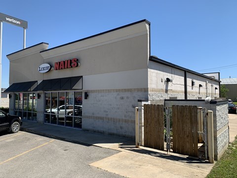A nail salon with a sign that says "Luxury Nails".