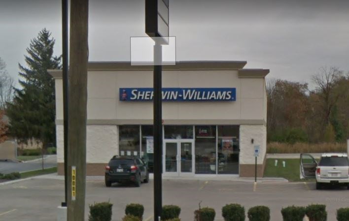 a building with a sign on it in front of a parking lot