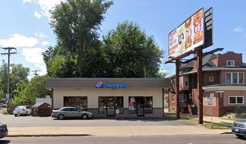 A Domino's Pizza restaurant with a sign advertising a $5.99 deal.