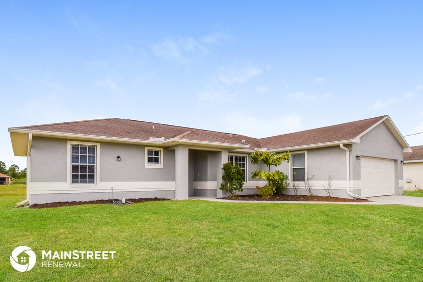 a white house with a lawn in front of it