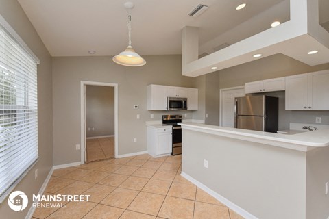 a kitchen with a counter top and a refrigerator