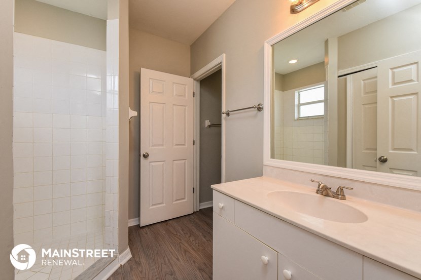 a bathroom with a sink and a mirror and a shower