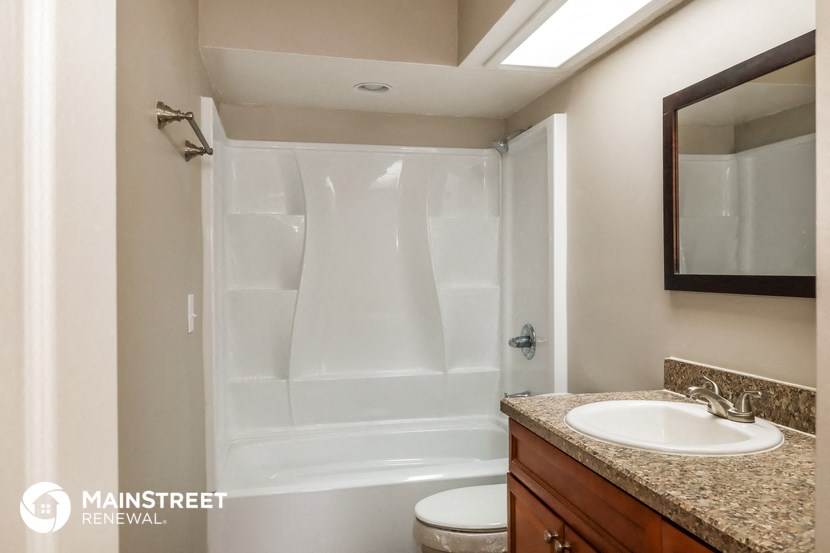 a bathroom with a shower and a sink and a mirror