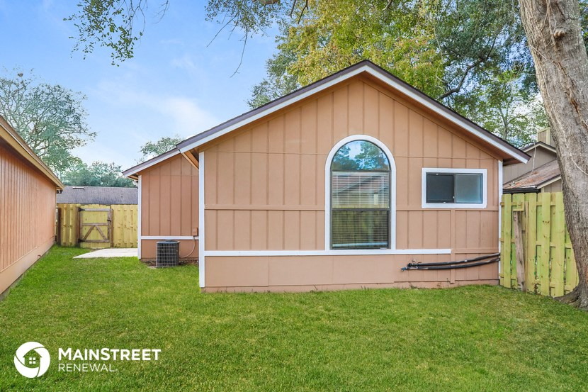 the exterior of a small house with a yard and a backyard
