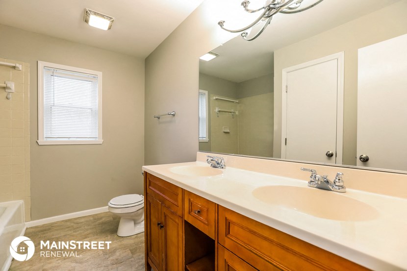 a bathroom with a sink and a toilet and a mirror