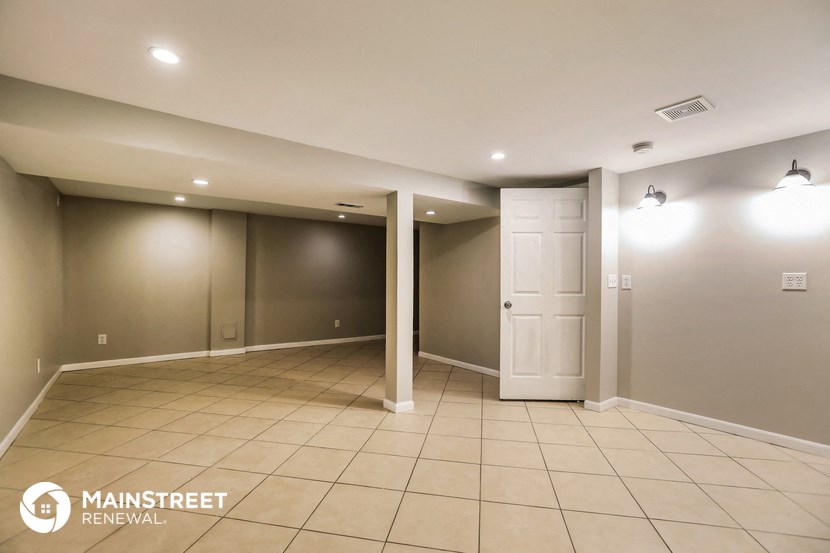 a empty room with a tile floor and a door