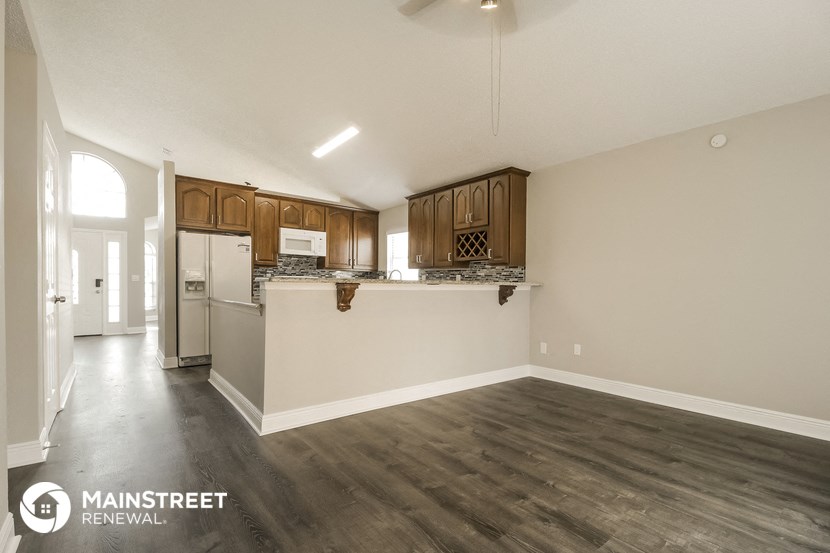the kitchen is open to the living room and dining room