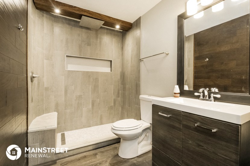 a bathroom with a toilet and a sink and a shower