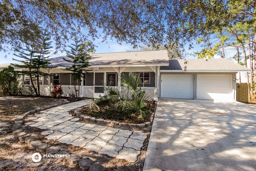 a white house with a driveway and a white garage door