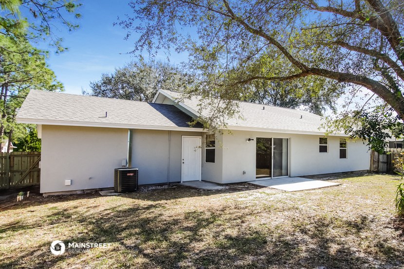 a white house with a yard and trees