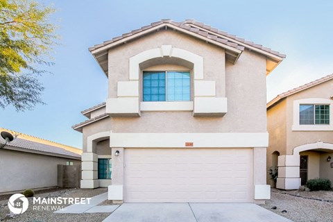a home with a white garage door in front of it