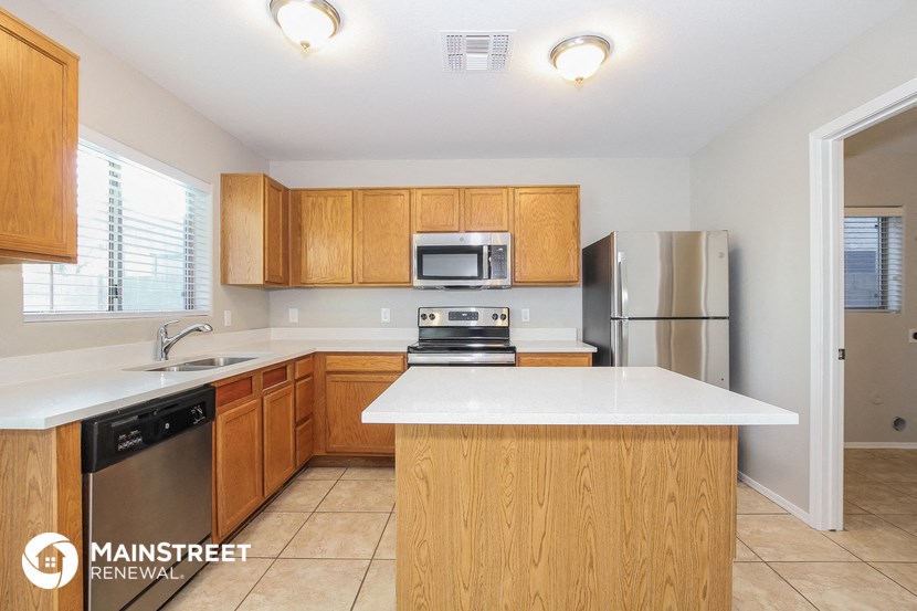 a kitchen with wooden cabinets and a white counter top
