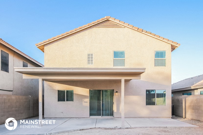 a beige house with a garage door in front of it
