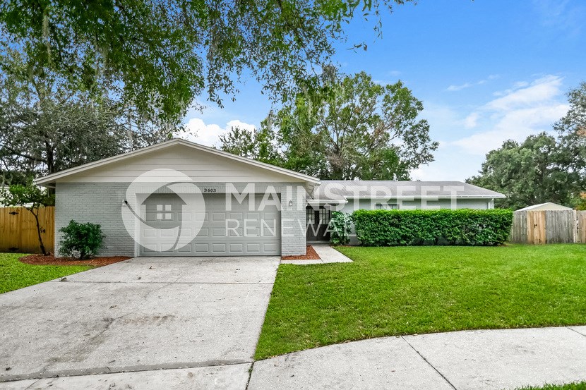 a home with a garage and a lawn