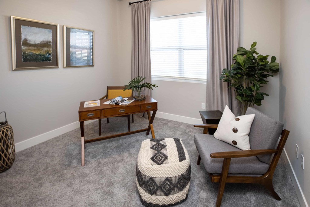 a living room with a couch and a chair and a table