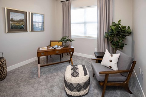 a living room with a couch and a chair and a table