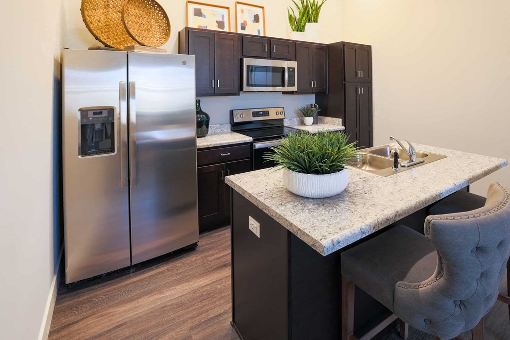 a kitchen with stainless steel appliances and a counter with a sink