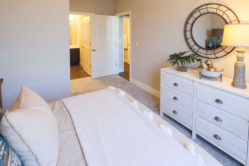 a bedroom with a bed and a mirror