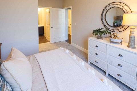 a bedroom with a bed and a mirror