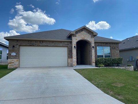 a house with a concrete driveway and a garage door