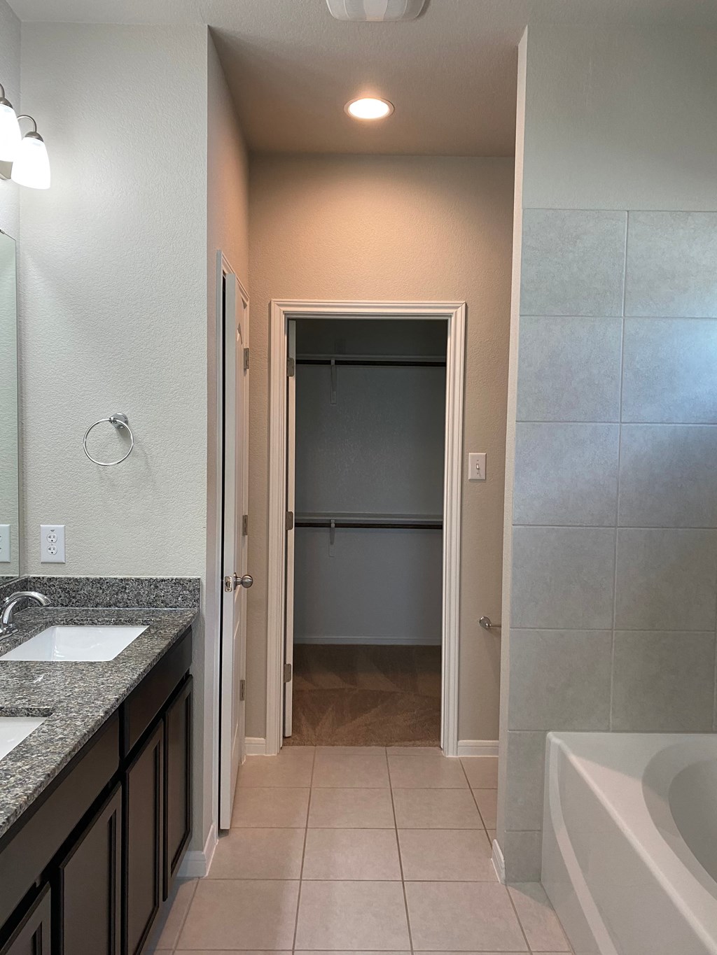 a bathroom with a tub and a shower and a sink