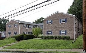 a brick apartment building on the side of a street