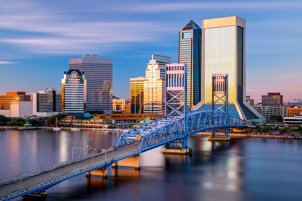 A cityscape with a blue bridge over a body of water.