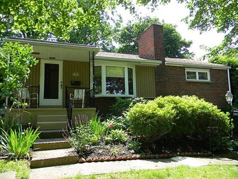 A house with a front porch and a small garden.
