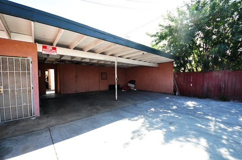 a parking lot with a building and a gate