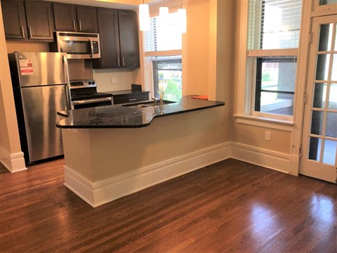 a kitchen with a counter top and a refrigerator