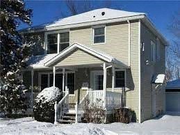 A house with a snow-covered front yard.