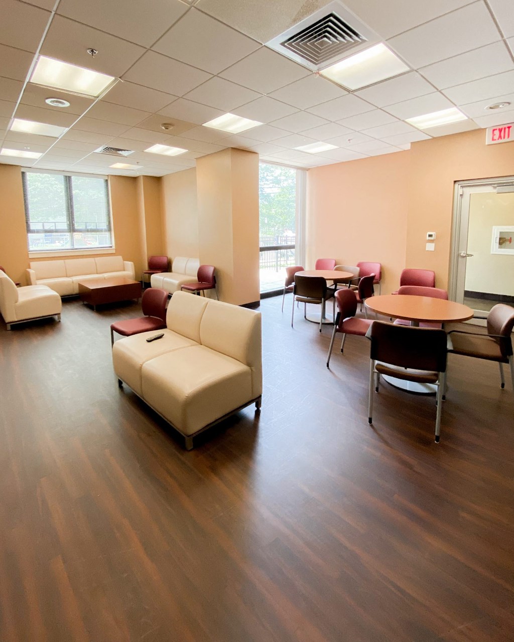 an empty waiting room with chairs and tables