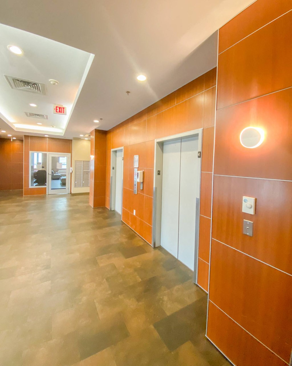 a large hallway with orange walls and a door