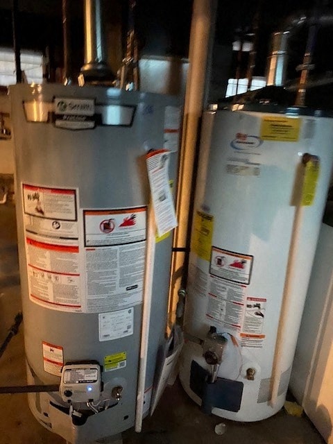 Two large metal tanks with stickers and labels on them.