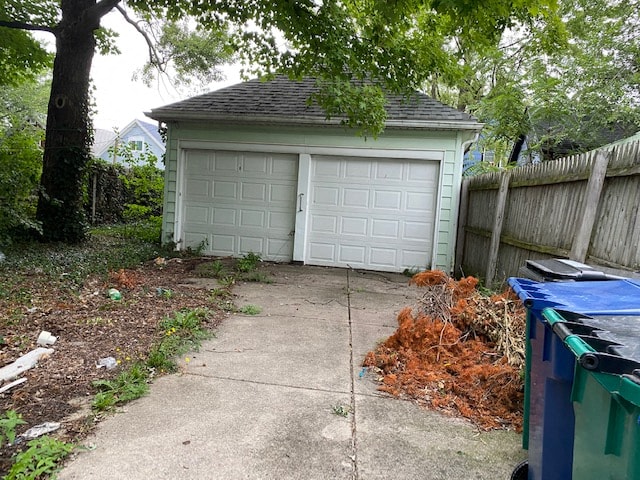 A white garage door is closed and the garage is white.