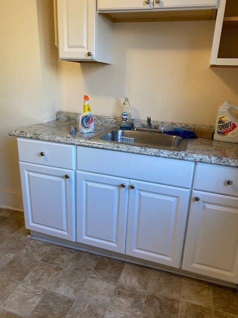 a kitchen with white cabinets and a sink