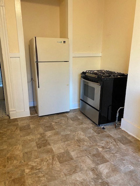 a kitchen with a refrigerator and a stove