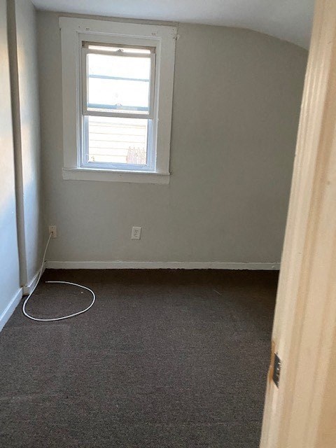 an empty room with a window and a carpet