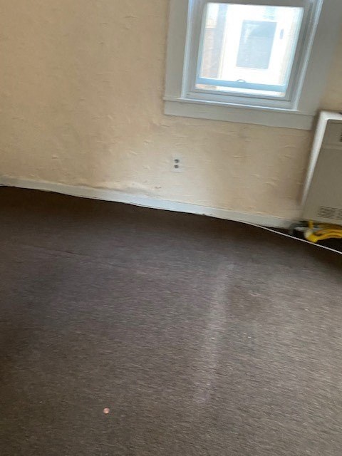 a room with a carpeted floor and a window